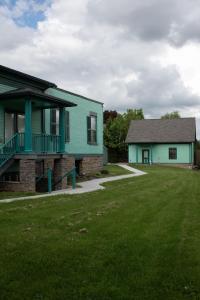 a green house and a house with a yard at The Nautilus at JS Hubbs Guest House in Hammondsport
