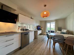 a kitchen and dining room with a table and chairs at Entre mer & piscine Maison familiale pour 6 in Brétignolles-sur-Mer
