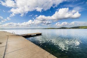 a dock on a large body of water at Sydney Apartment in Bilice