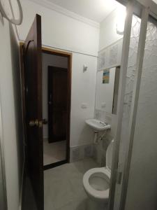 a bathroom with a toilet and a sink at El Palmar in Caucasia +15 photos