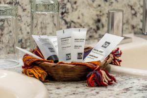 a basket of toiletries sitting on a bathroom counter at La Casona Hotel Boutique in La Paz +80 photos