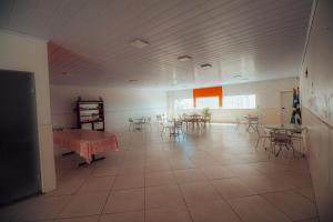 a large room with tables and chairs and a table at Hotel Pousada Zacarias in Anápolis