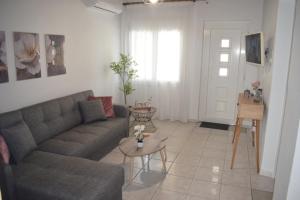 a living room with a couch and a table at Serenity in Kavala
