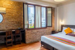 a bedroom with a bed and a brick wall at La Casona Hotel Boutique in La Paz +84 photos