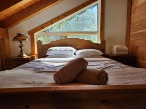 a bed in a room with a large window at Alpenrose 4, Hottub, Mountains View, AC, sleep 5 in Golden