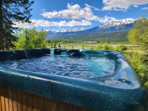 a hot tub with mountains in the background at Alpenrose 4, Hottub, Mountains View, AC, sleep 5 in Golden