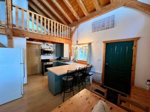a kitchen with a table and chairs in a room at Alpenrose 4, Hottub, Mountains View, AC, sleep 5 in Golden
