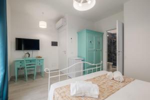 Postel nebo postele na pokoji v ubytování Sa Domu Colorada- Eleganza e comfort nel centro di Villasimius