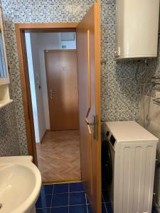 a bathroom with a sink and a washer and dryer at Apartmani JELENA Opatija in Opatija