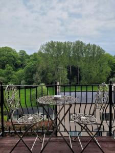 una mesa y dos sillas sentadas en una terraza en Luxury Penthouse on Waterside Knaresborough, en Knaresborough