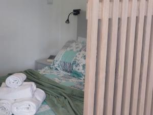 a bedroom with a bed with towels on it at Quinta Flor Dos Lagos - Eco Tiny Hause in Torre de Moncorvo +22 photos