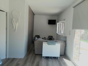 a living room with a couch and a table at Quinta Flor Dos Lagos - Eco Tiny Hause in Torre de Moncorvo