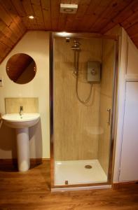 a bathroom with a shower and a sink at Heather Cottage in Lairg