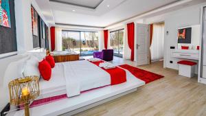 a bedroom with a large white bed with red pillows at Villa Yağmur Üzümlü in Kas +50 photos