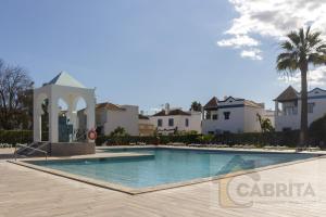 a villa with a swimming pool in a resort at Casa Margaret by YHA in Cabanas de Tavira