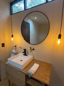 a bathroom with a sink and a mirror at Casa Yag in Brisas de Zicatela +20 photos