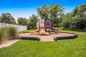 a playground with a slide in the grass at Millville by the Sea --- 35013 Sunfish Ln in Millville