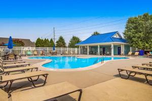 a swimming pool with chairs and a building at Millville by the Sea --- 35013 Sunfish Ln in Millville