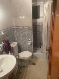 a bathroom with a toilet and a sink and a shower at house with flowers in Gran Alacant +16 photos
