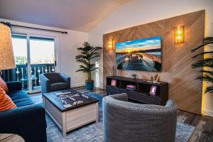 a living room with a couch and a tv at Luxury Couples Getaway w Dual Spa Shower 6308P1 in Saint Augustine