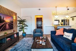 a living room with a blue couch and a table at Luxury Couples Getaway w Dual Spa Shower 6308P1 in Saint Augustine