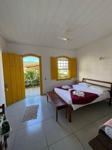 a bedroom with two beds and a window at Pousada Fortaleza in Paraty