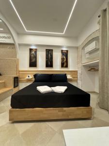 a bedroom with a bed with two books on it at San Domenico Dimora e Benessere in Putignano