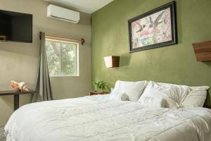 a bedroom with a large white bed and a window at Hokhmah Heart Hotel in Puerto Morelos +140 photos