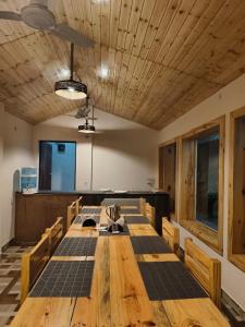 a conference room with a wooden table and chairs at Bhimtal Birding Lodge in Bhowāli
