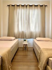 Ένα ή περισσότερα κρεβάτια σε δωμάτιο στο Apartamento Agradável próximo ao aeroporto