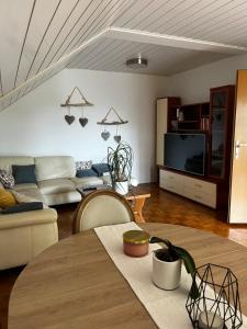 a living room with a couch and a table at Green Breeze - Private Hot Tub Retreat in Žalec
