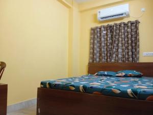 Postel nebo postele na pokoji v ubytování Rukmini Guest House