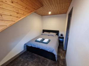 a bedroom with a bed with two towels on it at La Barroude in Bagnères-de-Bigorre