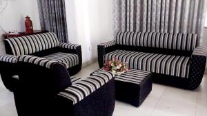 a living room with two chairs and a table with flowers at Salmanel Resort Ayagama - Rathnapura in Ratnapura +25 photos