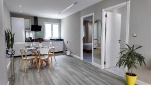 a kitchen and living room with a table and chairs at R&S Marina Bay Tanger in Tangier
