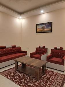 a living room with two couches and a coffee table at Castle INN Moutain Escape-3BHK Fully Loaded in Dehradun