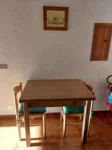a wooden table and chairs in a room at Le Melette - Lago di Bolsena in Capodimonte