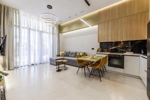 a kitchen and living room with a couch and a table at Emily Jacuzzi Veranda by PS in Durrës