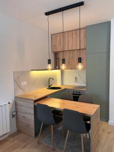 a kitchen with a wooden table and chairs at Adena in Bjelašnica