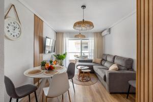 a living room with a couch and a table at Apartment Hola Amigo's Playa Los Locos in Torrevieja