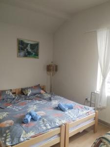 a bedroom with a bed with blue pillows on it at Aleksinac Centar Two-Bedroom Apartment in Aleksinac