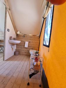 a bathroom with a sink and a toilet in a room at Casa Sgarlata Glamping - Tenda Palma Nana in Cava dʼAliga