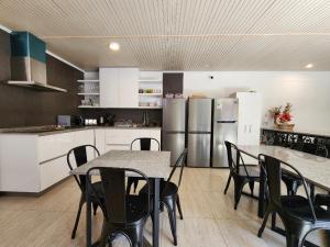 a kitchen with a table and chairs and refrigerator at Laredo top hotel boutique in Santiago