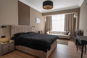 a bedroom with a bed and a living room at Amber Corner I Brand New Flat Top Location in Sofia