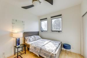 a bedroom with a bed and two windows at Pool and Trail Access On-Site Barton Creek Condo! in Austin