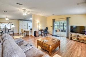 a living room with a couch and a table at Boat Dock and Waterfront Deck Home in Satsuma! in Satsuma