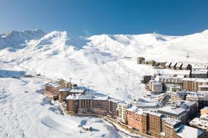 a city in the snow with a mountain in the background at Sky 101 by Confortsky in Pas de la Casa