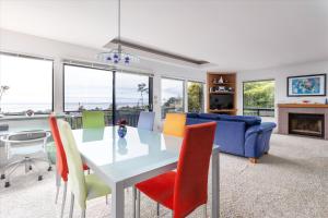 a dining room and living room with a table and chairs at Snug Harbor in Cambria