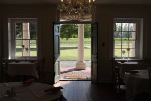 a dining room with tables and a chandelier at Ormond Manor in Destrehan