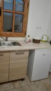 a kitchen counter with a sink and a window at House Under the Pines next to the sea in Mesochórion +31 photos